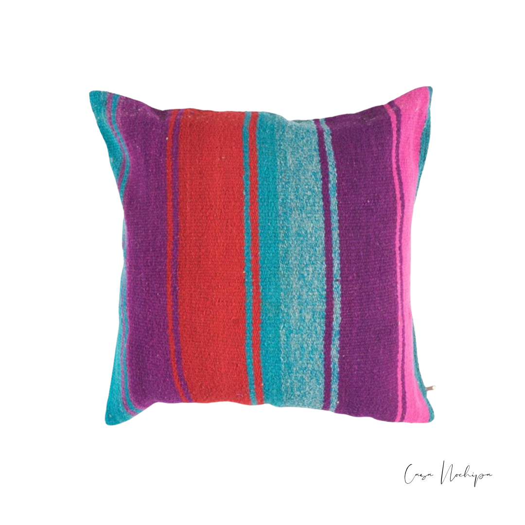 Cojín de lana multicolor vibrante tejido en telar de pedal artesanal en Oaxaca